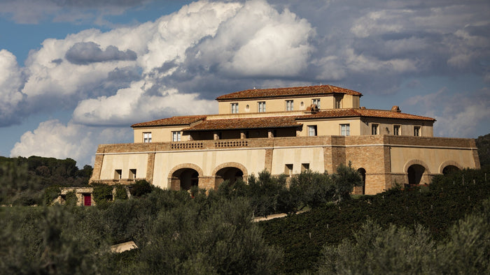 Tenuta Argentiera's winery built low into the Bolgheri hillside under a wide coastal sky. Image: Courtesy of Tenuta Argentiera, photo Moggi.
