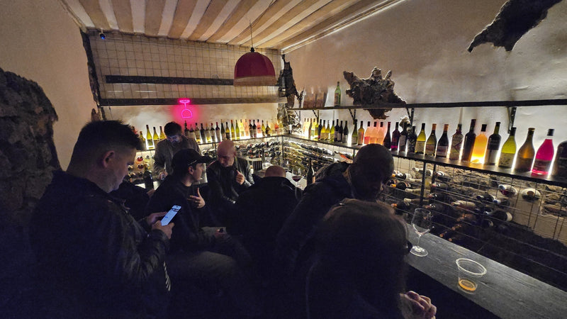 Young drinkers in a candlelit underground wine bar in Yerevan, Armenia, the kind of place Gen Z actually chooses for wine