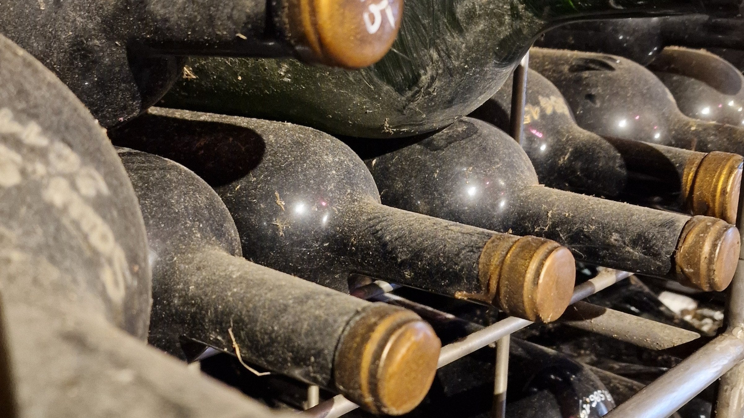Crate of wax-sealed natural wine bottles in a cellar in Steiermark, Austria