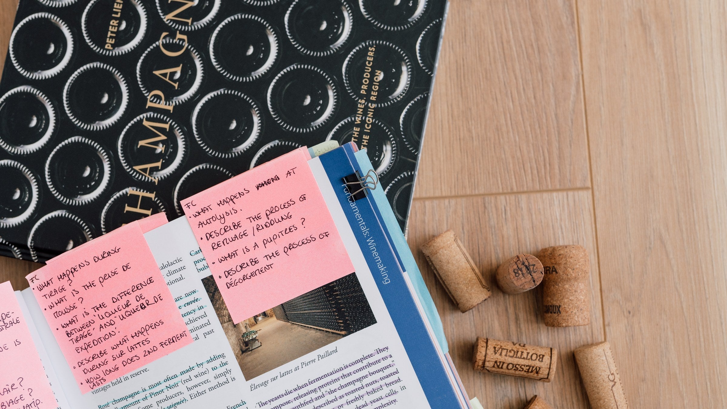 Peter Liem Champagne book beside an open wine textbook tabbed with handwritten flashcard questions and used Champagne corks, illustrating the 3-Pile Method on Wine with Margot