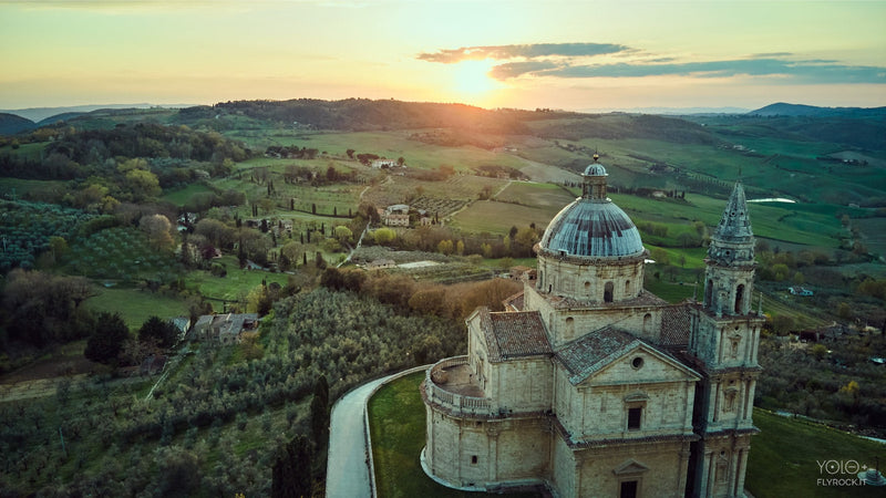 Sunset over the San Biagio church and the rolling vineyard hills of Montepulciano, Tuscany, photo Flyrock.it